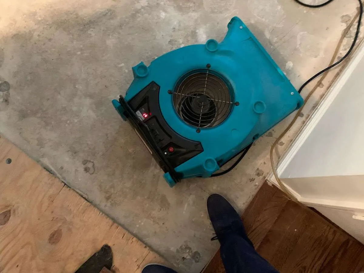Air mover drying subfloor during Leak Detection & Repair in Forrest City